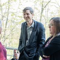 Group of three event guests standing outside and chatting